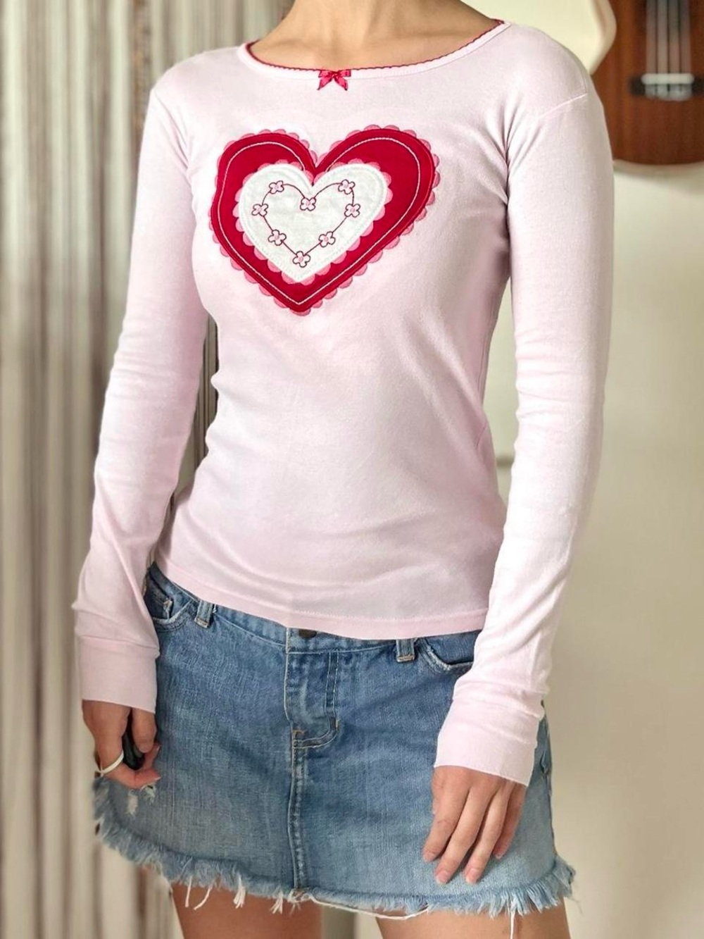 pink long sleeve top with heart embroidery and bow
